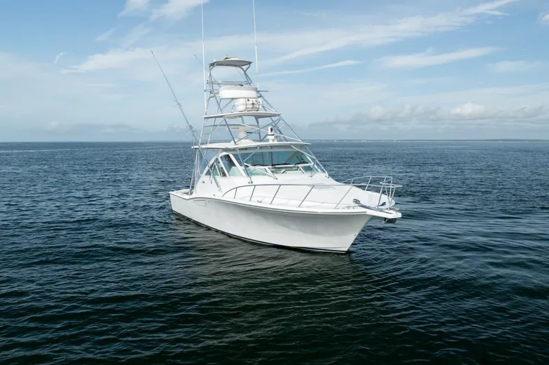 Slide: The Image of 2011 Cabo 36 Express boat on open water under a clear sky. - 10