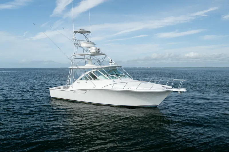 Slide: The Image of 2011 Cabo 36 Express boat on calm ocean waters under a clear sky. - 11