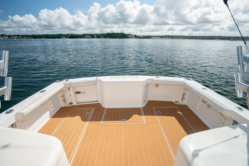 Slide: The Image of 2011 Cabo 36 Express boat deck overlooking serene water and cloudy sky. - 23