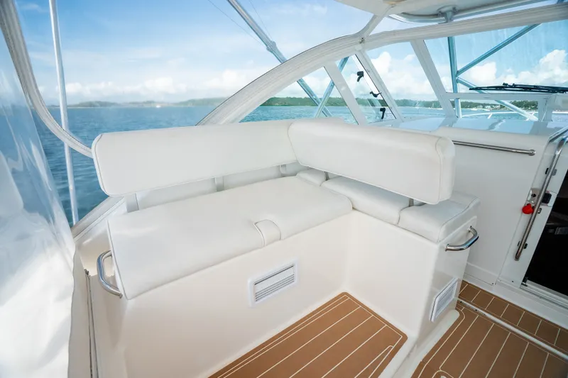 Slide: The Image of 2011 Cabo 36 Express boat interior with white seating and ocean view. - 31