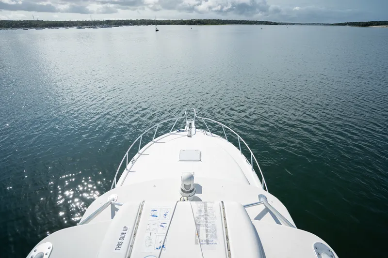 Slide: The Image of Bow view of 2011 Cabo 36 Express yacht on calm waters under cloudy sky. - 20