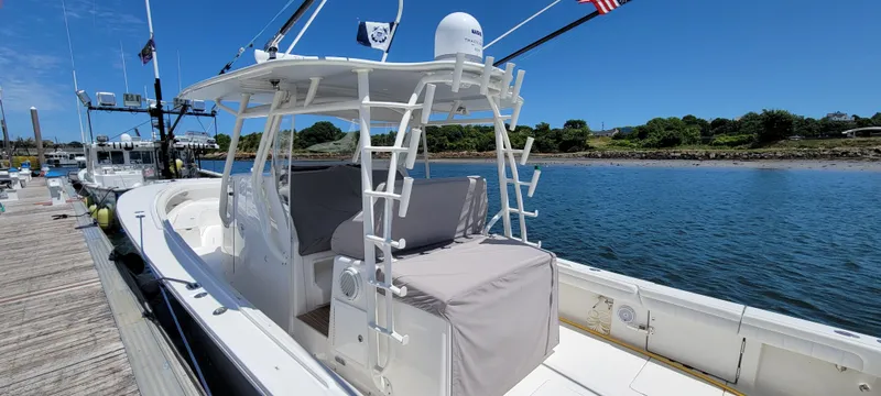 Slide: The Image of 2018 Regulator 41 Center Console boat docked by the water. - 21