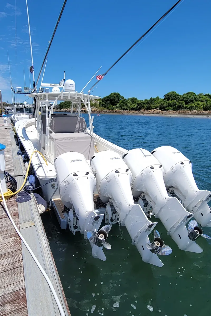 Slide: The Image of 2018 Regulator 41 Center Console boat docked with four outboard engines. - 23
