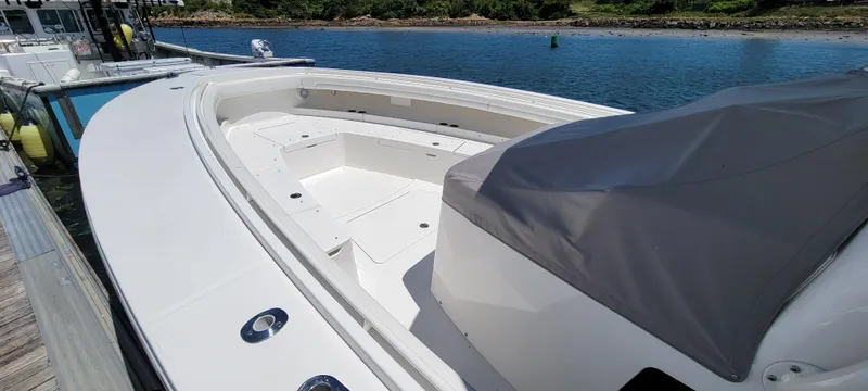 Slide: The Image of 2018 Regulator 41 Center Console boat docked by the water. - 22