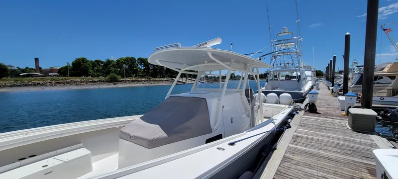 Slide: The Image of 2018 Regulator 41 Center Console boat docked at a marina on a sunny day. - 16