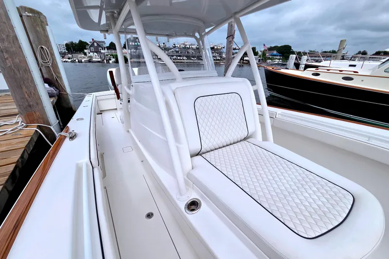 Slide: The Image of 2021 Valhalla Boatworks V-33 with white seating, docked at a marina. - 19