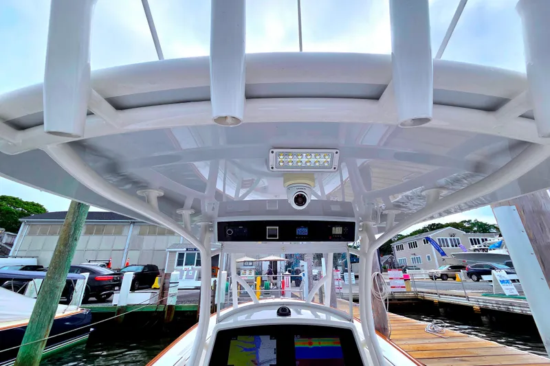 Slide: The Image of 2021 Valhalla Boatworks V-33 helm with advanced navigation and lighting systems at a marina. - 14