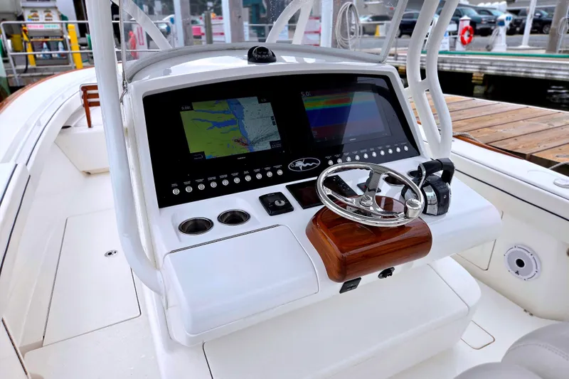 Slide: The Image of 2021 Valhalla Boatworks V-33 helm with navigation screens and steering wheel. - 15