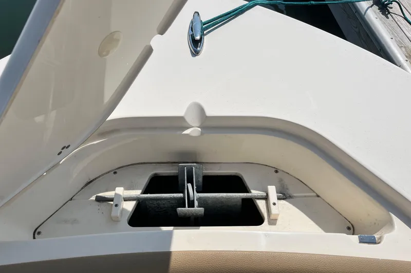 Slide: The Image of Anchor compartment of a 2021 Scout 215 XSF boat, open lid view. - 35