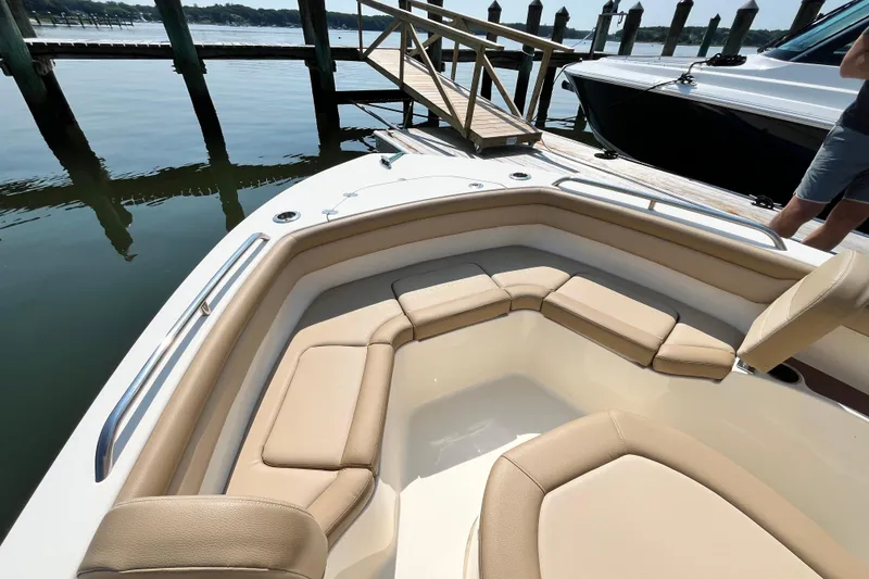 Slide: The Image of 2021 Scout 215 XSF boat with beige seating, docked by a wooden pier. - 25