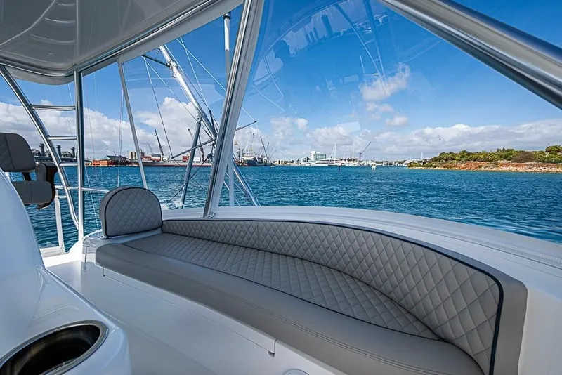 Slide: The Image of 2026 Viking 54 Convertible yacht interior with ocean view and luxurious seating. - 25