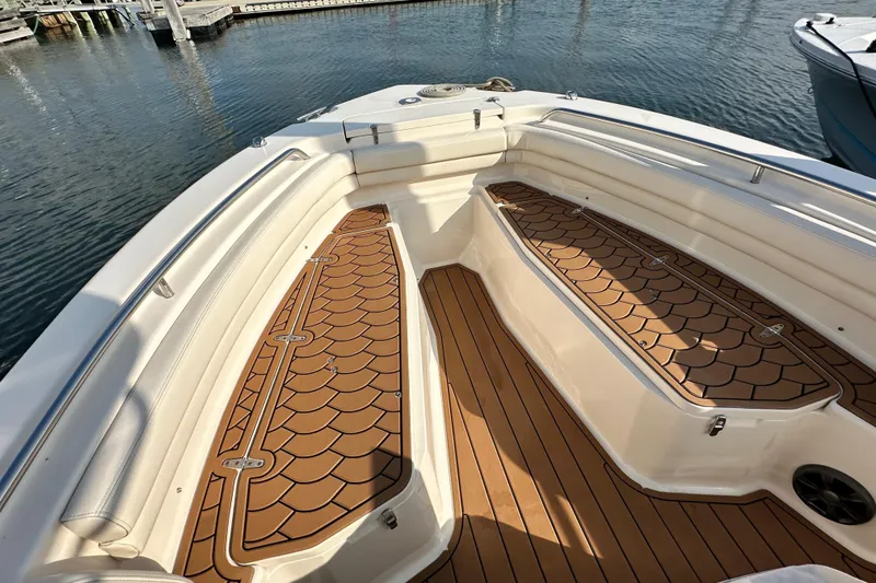 Slide: The Image of 2019 Grady-White Fisherman 257 boat interior with teak flooring at marina. - 20