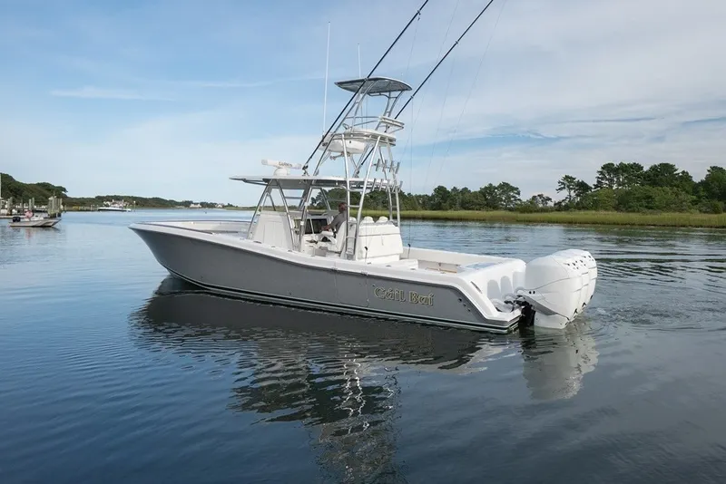 Slide: The Image of 2023 Invincible 39 Open Fisherman boat on calm water, featuring sleek design and powerful engines. - 12