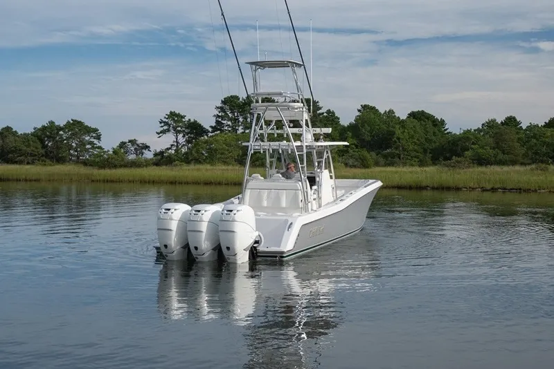 Slide: The Image of 2023 Invincible 39 Open Fisherman boat with triple engines on calm water. - 4