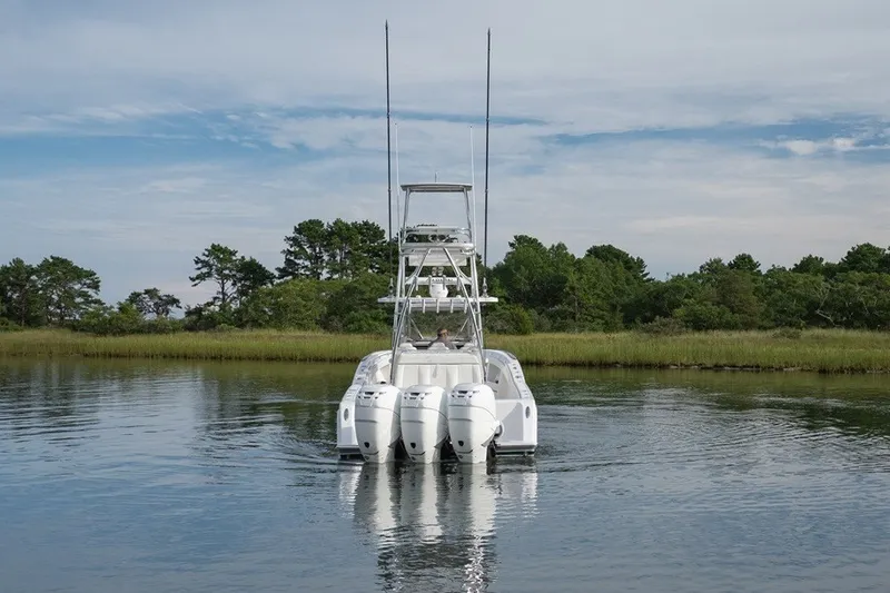 Slide: The Image of 2023 Invincible 39 Open Fisherman boat with triple engines on calm water. - 3