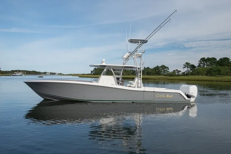 Slide: The Image of 2023 Invincible 39 Open Fisherman boat on calm water, side view. - 11