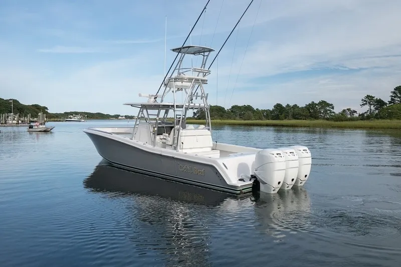 Slide: The Image of 2023 Invincible 39 Open Fisherman boat with triple outboard engines on calm water. - 13