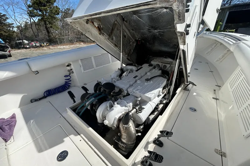 Slide: The Image of 2006 Albin 26 Center Console boat engine compartment with open hatch, showcasing the engine. - 40