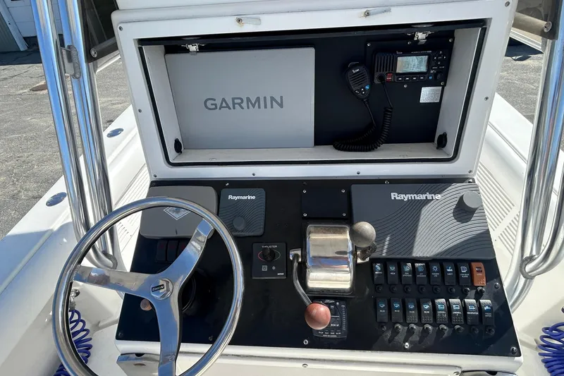 Slide: The Image of 2006 Albin 26 Center Console dashboard with Garmin and Raymarine electronics. - 16