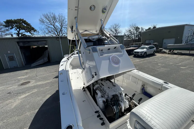 Slide: The Image of 2006 Albin 26 Center Console boat with open engine compartment in a marina setting. - 39