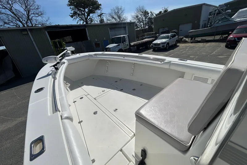 Slide: The Image of 2006 Albin 26 Center Console boat with spacious deck and seating in a marina setting. - 21