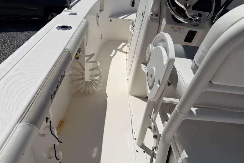 Slide: The Image of Interior view of a 2013 Everglades 210 Center Console boat, showcasing seating and steering area. - 24