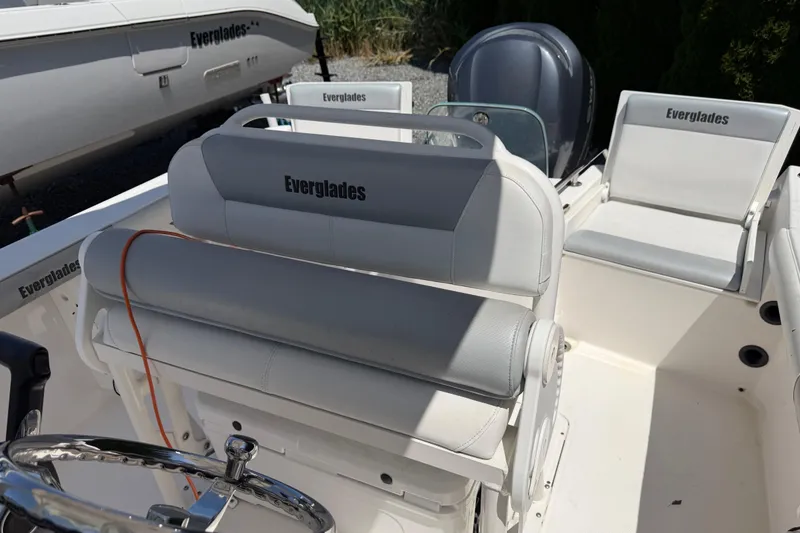 Slide: The Image of 2013 Everglades 210 Center Console boat interior with seating and steering wheel. - 18