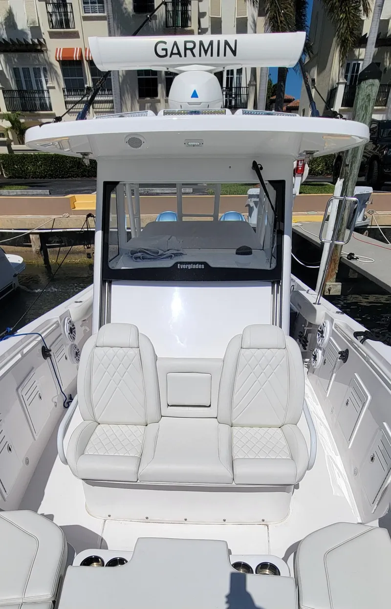 Slide: The Image of 2024 Everglades 365 Center Console boat with Garmin equipment, docked at a marina. - 16