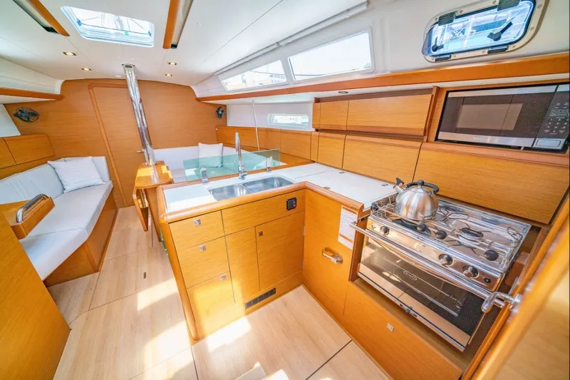 Slide: The Image of Modern interior of 2021 Jeanneau Sun Odyssey 389 yacht with kitchen and seating area. - 4