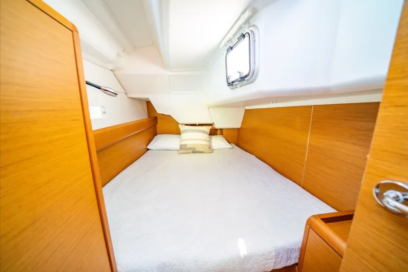 Slide: The Image of Cozy cabin interior of 2021 Jeanneau Sun Odyssey 389 sailboat with wooden finish. - 8