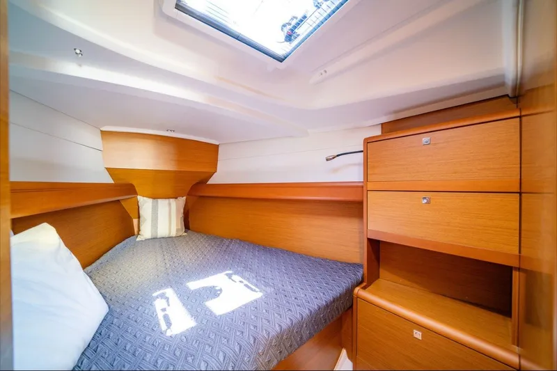 Slide: The Image of Cozy cabin interior of 2021 Jeanneau Sun Odyssey 389 sailboat with wooden furnishings. - 6