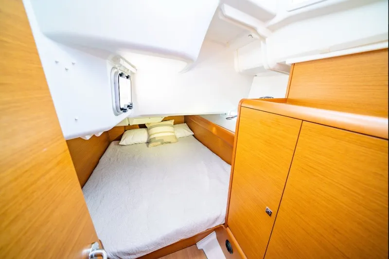 Slide: The Image of Cozy cabin interior of 2021 Jeanneau Sun Odyssey 389 sailboat with wooden finish. - 7