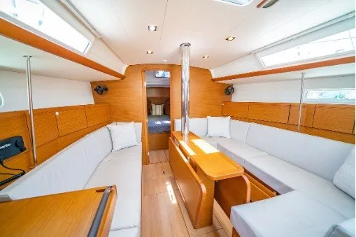 Slide: The Image of Interior of 2021 Jeanneau Sun Odyssey 389 sailboat with modern wood finish and spacious seating. - 3