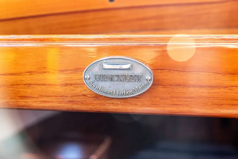 Slide: The Image of Hinckley Picnic Boat 36 Classic 1998 nameplate on polished wood surface. - 53