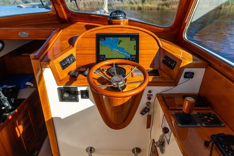 Slide: The Image of Helm of 1998 Hinckley Picnic Boat 36 Classic with wooden finish and navigation display. - 29