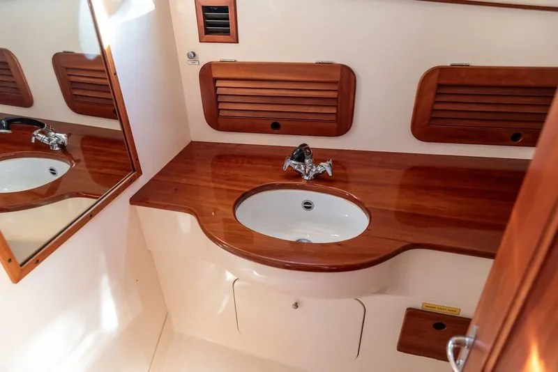 Slide: The Image of Hinckley Picnic Boat 36 Classic 1998 bathroom with wooden countertop and sink. - 49