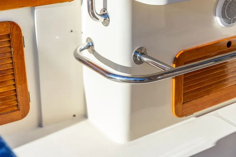 Slide: The Image of Hinckley Picnic Boat 36 Classic 1998 interior detail with wood accents and metal railing. - 25