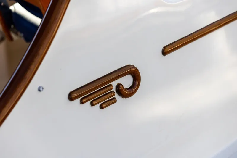 Slide: The Image of Close-up of 1998 Hinckley Picnic Boat 36 Classic logo on white surface. - 16