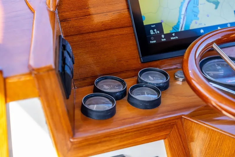 Slide: The Image of Dashboard of a 1998 Hinckley Picnic Boat 36 Classic with wooden finish and navigation instruments. - 33