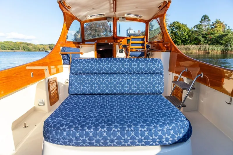 Slide: The Image of 1998 Hinckley Picnic Boat 36 Classic interior with blue patterned seating and wooden accents. - 22