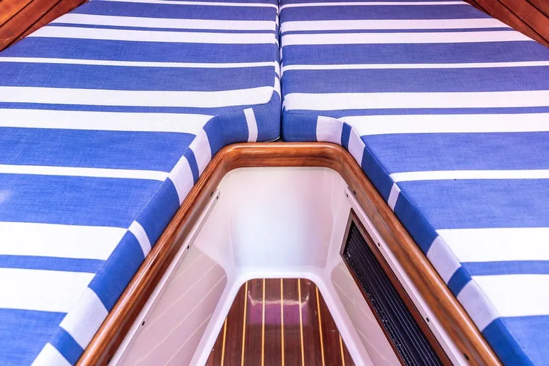 Slide: The Image of Interior of 1998 Hinckley Picnic Boat 36 Classic with blue striped cushions. - 43