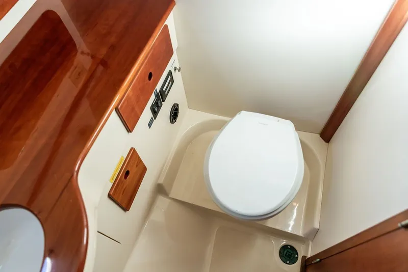 Slide: The Image of 1998 Hinckley Picnic Boat 36 Classic bathroom with wooden accents and modern fixtures. - 50