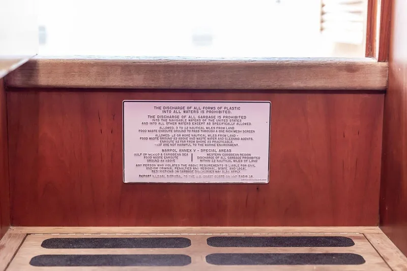 Slide: The Image of Hinckley Picnic Boat 36 Classic 1998 interior with waste discharge regulations sign. - 37
