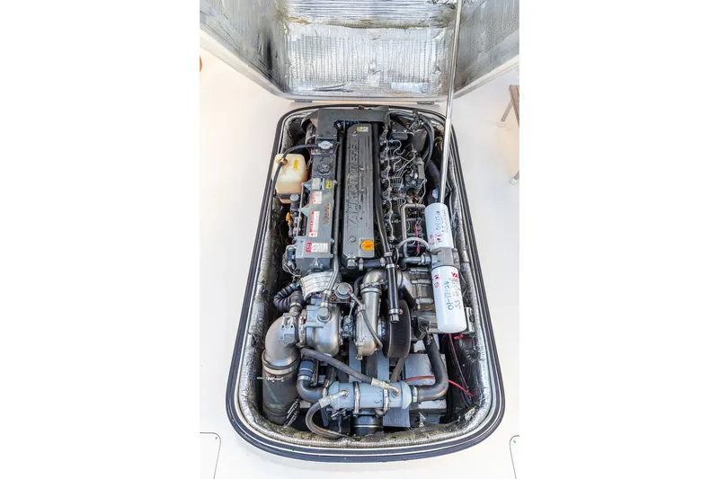 Slide: The Image of Engine compartment of a 1998 Hinckley Picnic Boat 36 Classic, showcasing detailed mechanical components. - 57