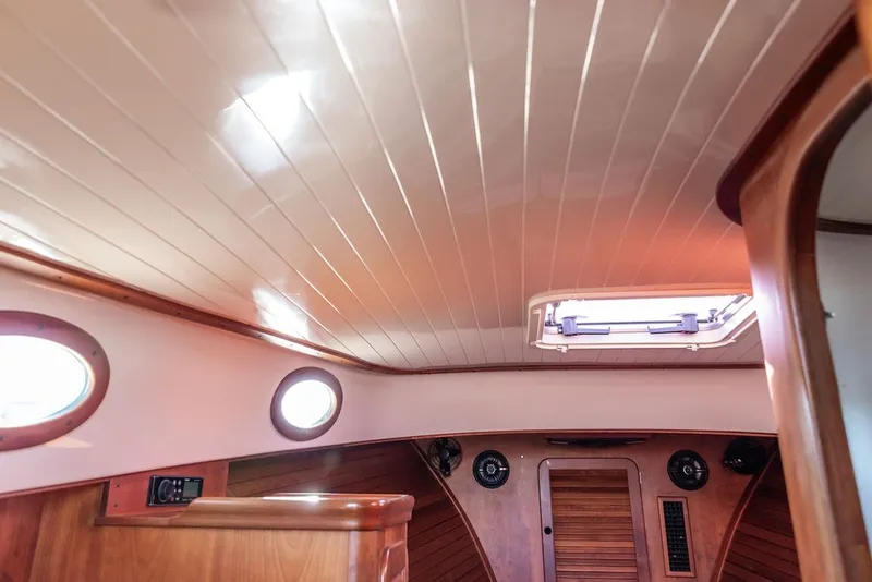 Slide: The Image of Interior of 1998 Hinckley Picnic Boat 36 Classic with wooden accents and portholes. - 38