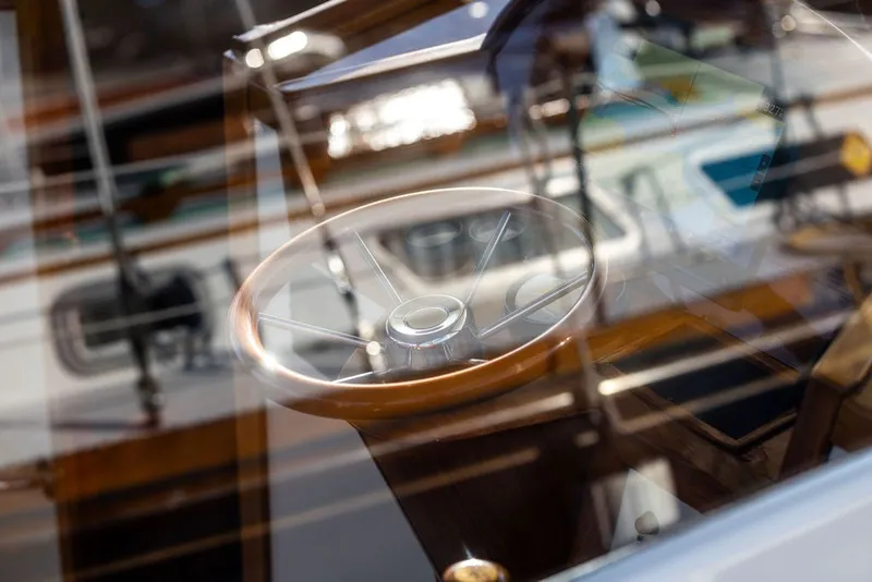 Slide: The Image of Steering wheel of a 1998 Hinckley Picnic Boat 36 Classic, reflecting sunlight. - 17
