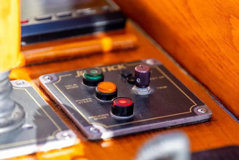 Slide: The Image of Control panel of a 1998 Hinckley Picnic Boat 36 Classic with colorful buttons and knobs. - 34