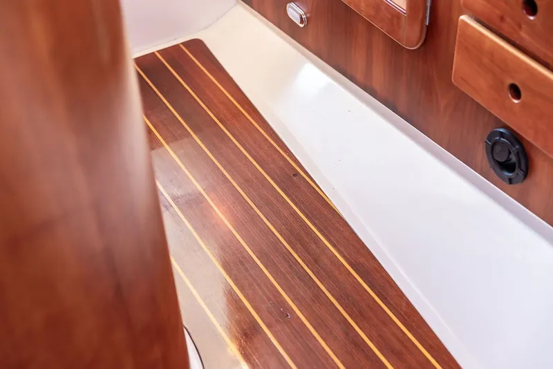 Slide: The Image of Hinckley Picnic Boat 36 Classic 1998 interior with polished wooden flooring and paneling. - 42