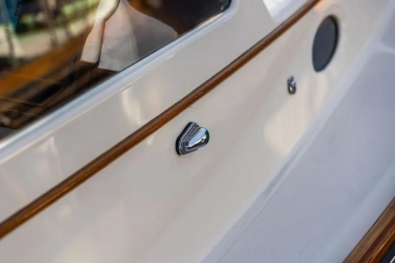 Slide: The Image of Close-up of 1998 Hinckley Picnic Boat 36 Classic's polished chrome detail and wooden trim. - 58