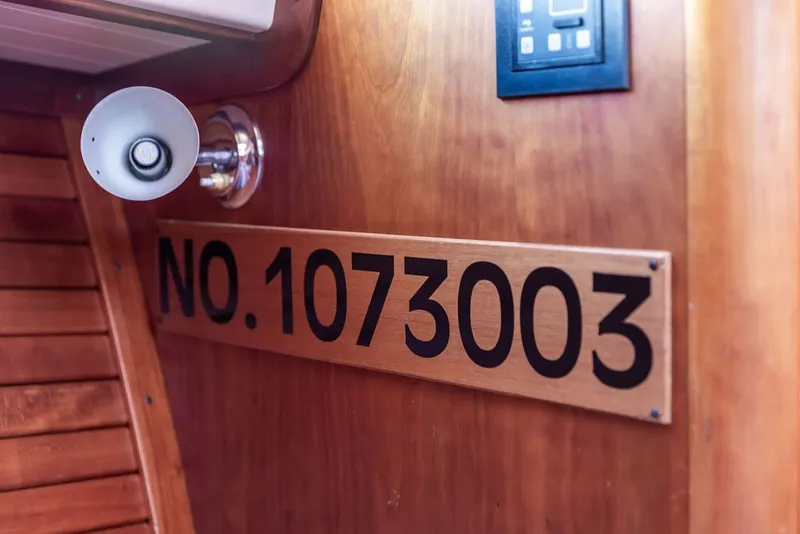 Slide: The Image of Interior of 1998 Hinckley Picnic Boat 36 Classic with number 1073003 displayed on wooden panel. - 54